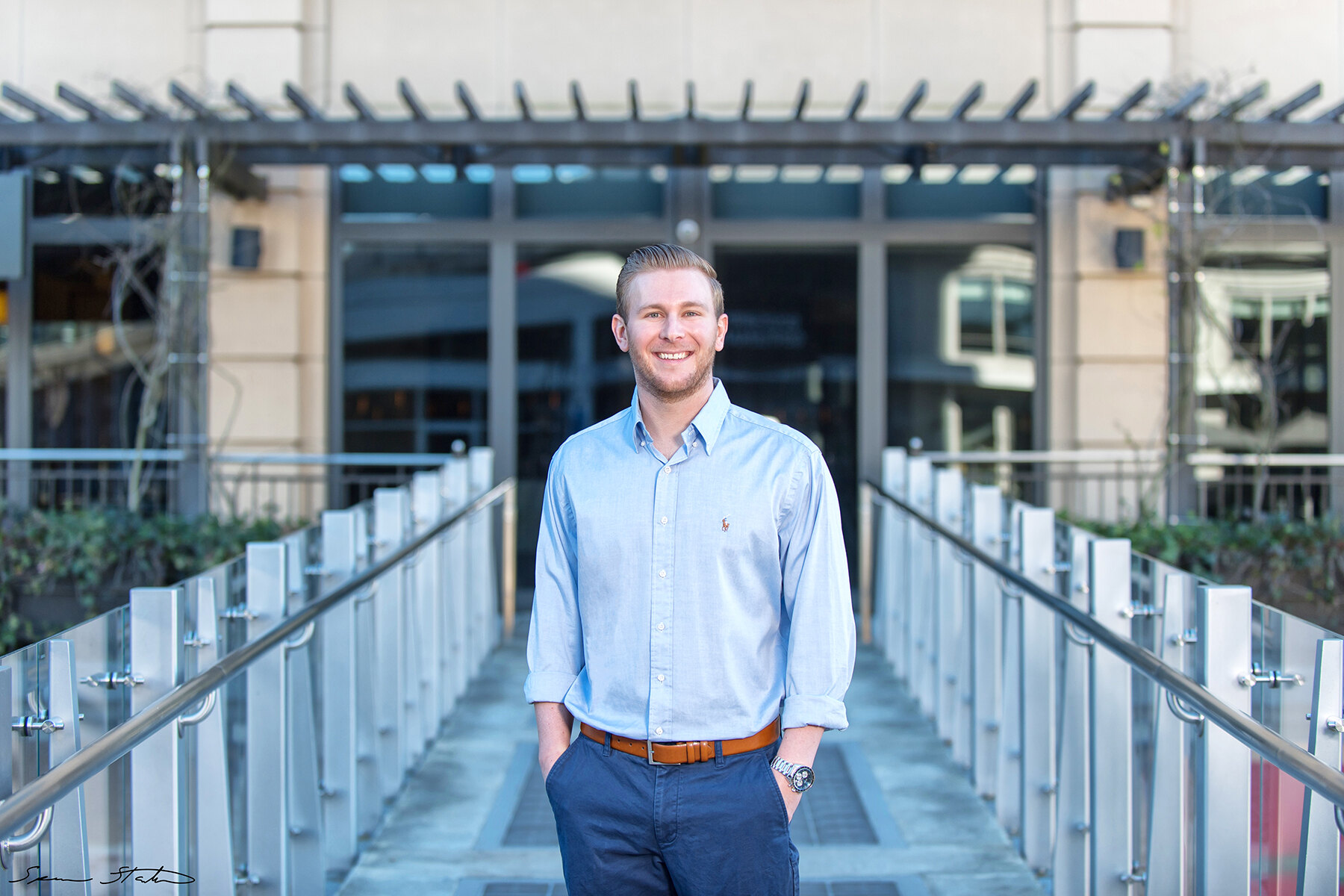 Entrepreneur Ryan White, founder of Social Revelation, in a light blue shirt standing on an outdoor walkway